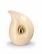 Teardrop cremation urn for ashes made of beige ceramic with small gold-coloured teardrop