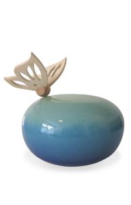 Handmade blue infant cremation urn with wooden butterfly