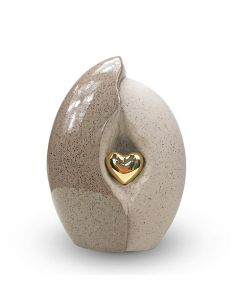 Ceramic funeral urn with gold-coloured heart