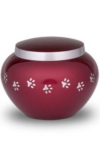 Red pet urn with silver coloured pawprints | Medium